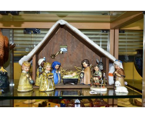 A GOEBEL JANET ROBSON NINE PIECE NATIVITY SET, with a wooden stable/building, comprises baby Jesus in the manger, Mary, Josep