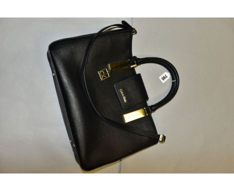 A CALVIN KLEIN BLACK LEATHER HANDBAG, fitted with detachable shoulder strap, carry handles, over the top strap with magnetic 