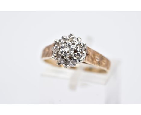 A 9CT GOLD DIAMOND CLUSTER RING, designed with a raised cluster set with star set single cut diamonds to the textured shoulde