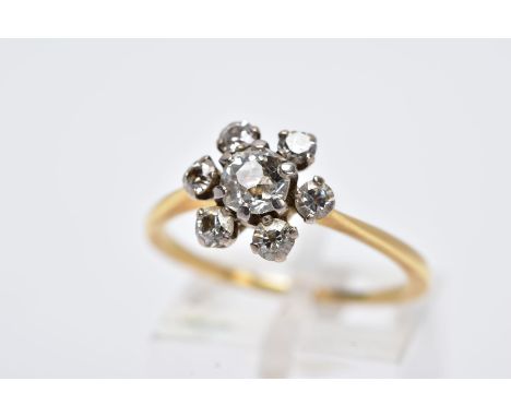 A YELLOW METAL DIAMOND CLUSTER RING, of a flower design, set with a central old cut diamond within an old cut diamond surroun