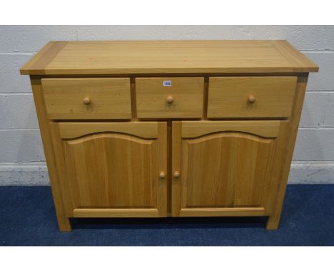 A SOLID LIGHT OAK SIDEBOARD, with three drawers, width 120cm x depth 45cm x height 90cm