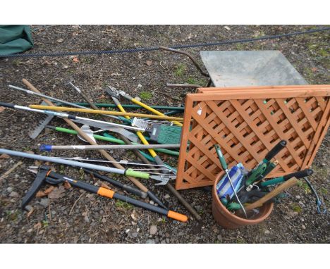 A QUANTITY OF GARDEN TOOLS to include a lopper, de-weeder, rake, broom, shears etc together with a galvanised wheel barrow, a