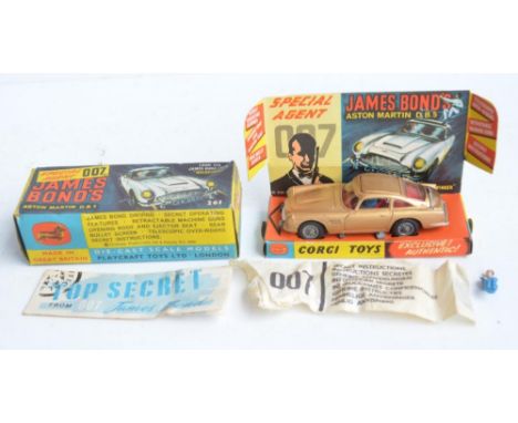 Vintage boxed Corgi 261 James Bond gold coloured Aston Martin DB5, model in good overall condition, some corrosion to silver 
