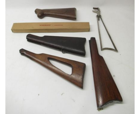 Selection of five gun butts for various rifles and other accessories, including musket butt with brass patch compartment and 