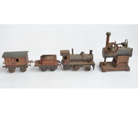 Vintage live stationary steam engine stamped DRGM to rear and a vintage push along train model with loco, tender and one carr