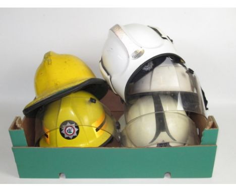 Five British vintage firefighter helmets of various styles and eras, including a c1990 Cromwell 'Firepro' North Yorkshire hel