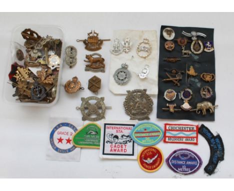 Collection of military and civilian metal/ cloth badges. Highland Regiment, Leicestershire Regiment, Royal Military School, 1