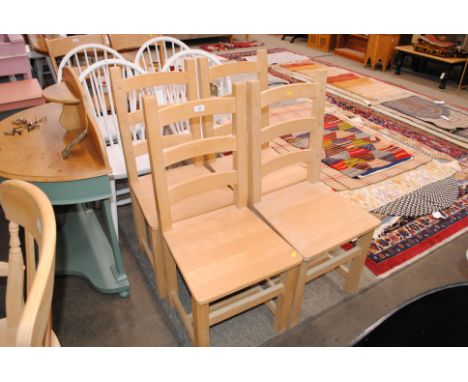 A set of four pine ladder back kitchen chairs
