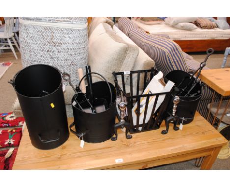 A collection of black metalware fireplace items, including coal scuttles, log basket, numerous implements and implement rests