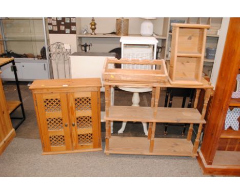 A pine three tier whatnot, a pine wall cupboard with pierced doors, a pine two tier shelf and a pine wine rack