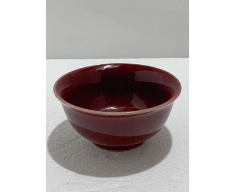 A Chinese Ox-Blood Bowl, Xuande Mark, Probably 18th century, D. 11.7 cm, H.5.8 cm Provenance: Estate of the Lam's family from