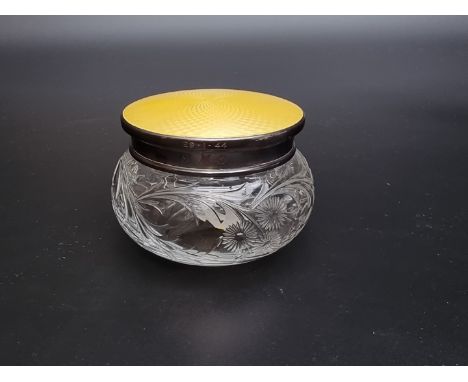 A silver and yellow guilloche enamel lidded cut glass jar,&nbsp;by&nbsp;Beddoes &amp; Co, Birmingham 1931, 9cm diameter at ba