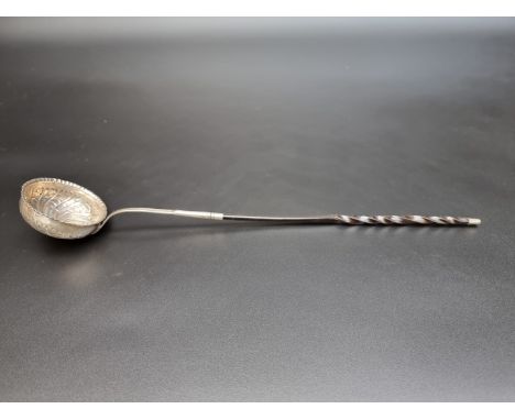 An antique white metal toddy ladle, having twisted baleen handle, 35cm. 