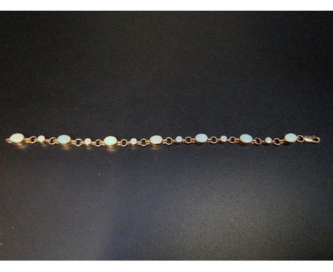 A yellow metal opal bracelet, stamped 9ct to clasp, 20cm. 