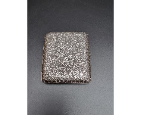 An Anglo Indian white metal cigarette case, having chased floral decoration, 87mm. 