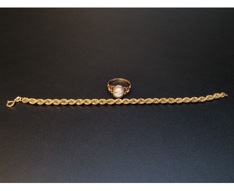 A yellow metal hollow link rope twist bracelet stamped 9k, 18cm, 3.6g; together with a 9ct gold ring, set carved shell cameo,