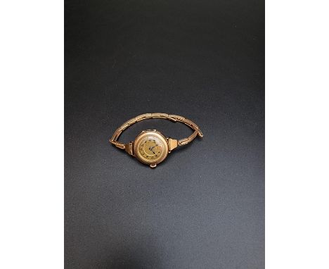 A vintage gold-filled manual wind ladies wristwatch, 26mm, on expanding bracelet stamped 9ct. 