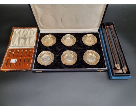 A cased set of six white metal cocktail sticks, having cockerel terminals, stamped 'Sterling Silver', 8cm; together with a ca