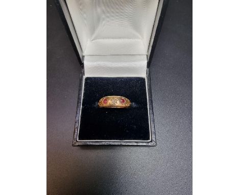 A yellow metal ruby and diamond gypsy ring, stamped 9ct, size P. 