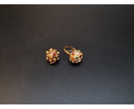 A Persian yellow metal ring, set semi precious gemstones, stamped 750, size L; together with a similar ball pendant, 14mm dia