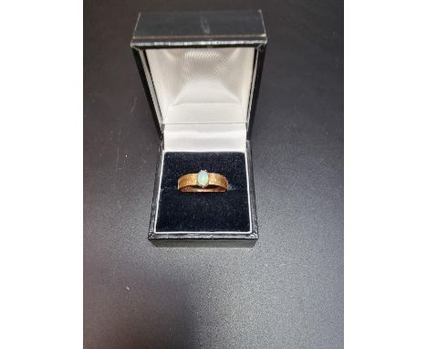 A yellow metal opal ring, size R. 