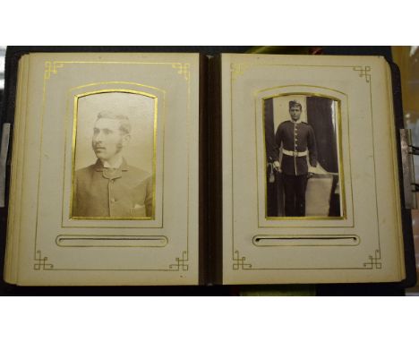 A Victorian embossed morocco photograph album, enclosing contemporary carte de visite portraits of a Victorian family, includ