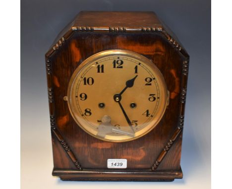 An early 20th century oak cased striking mantel clock, gilt dial, Arabic numerals, twin winding holes