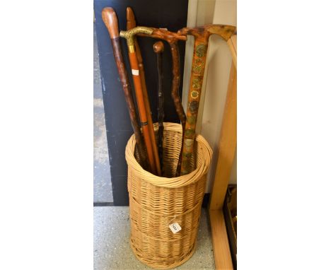 A quantity of walking canes, to include novelty whisky flask cane, an alpine walking stick, a carved African cane, etc.; all 