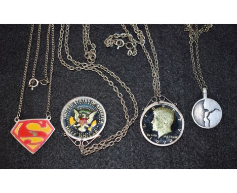 Two Kennedy Liberty enamel half dollars, 1971-72; a silver pendant; etc.; on neckchains