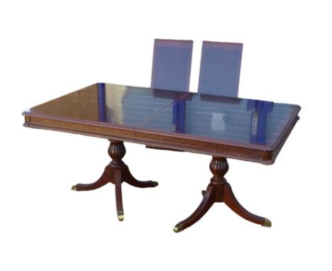 A reproduction twin pedestal dining table, with two additional leaves, draw action, 179 by 110 by 77cm high, fully extended, 