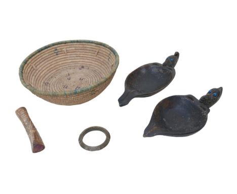A collection of tribal items, including two carved hardwood libation cups with beast headed handles inlaid with blue beads, l
