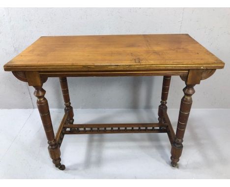 Occasional table on turned legs with ornate stretcher and original ceramic castors, approx 92cm x 46cm 73cm