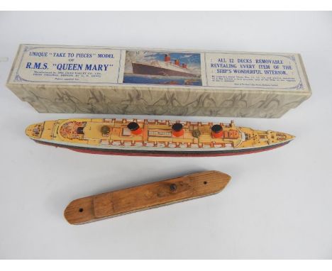 Chad Valley scale model of RMS Queen Mary, with twelve removable decks (boxed) and a carved wooden model of a ship (2)