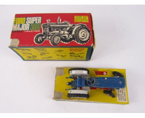 A Britains Models Ford Super Major 5000 tractor, in blue metal, on card base, (partially boxed), (AF).