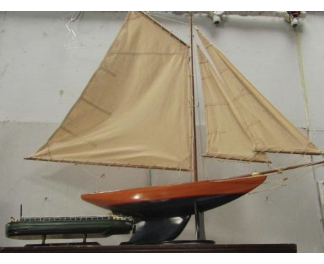 A scale model yacht, fully rigged, on stand, 98cm long, together with a model coaling barge 'Freedom' 38cm long, (2).