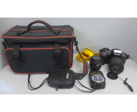 A Nikon AF F-600 camera with additional 35-70mm lens, a light meter and bag 