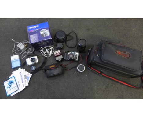 A collection of camera equipment and lenses including an Olympus Camedia C-740 