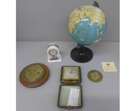 A small globe, clock, travel clock, a 40 year calendar and a pocket brass barometer guide/forecaster 