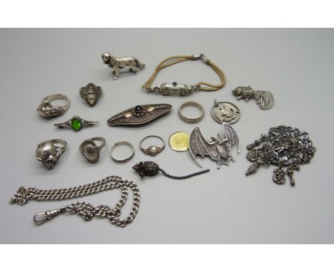 A silver skull ring, other rings, a hallmarked silver dog figure, 25g, a silver bat brooch, a silver mouse brooch, a cocktail