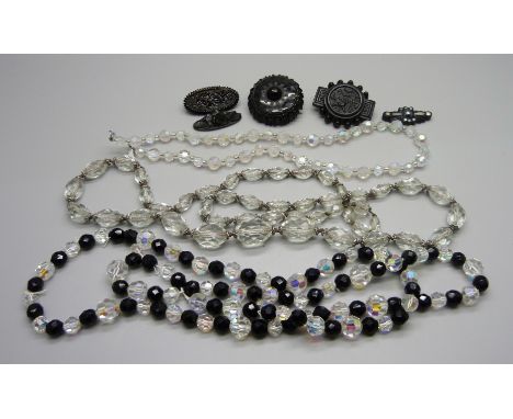 Three jet brooches, one set with mother of pearl, lacking pin, and three vintage glass bead necklaces 