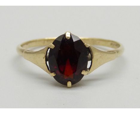 A yellow metal garnet solitaire ring, mark worn, 1.2g, M 