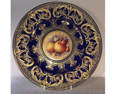 A Royal Worcester fine bone china cobalt blue and gilt overlaid plate, with central hand painted apples and cherries, signed 