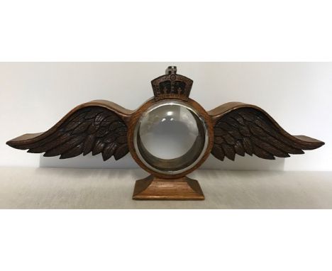 Oak clock case in the form of RAF wings with crown to top. 45cm tip to tip width