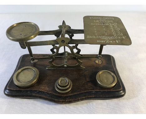 Set of brass postal scales with weights.