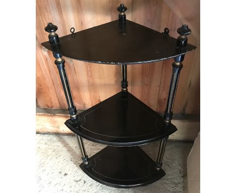 An ebonized corner wall shelf, 65cms h. 