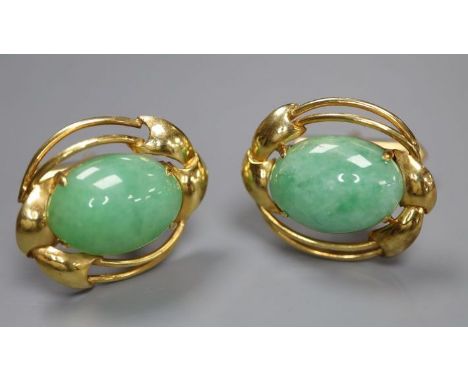 A pair of 585 yellow metal and oval cabochon jade set cufflinks, gross 12.2 grams, cabochon size approx. 16.5mm by 11.9mm.