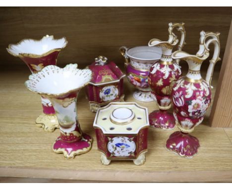 A group of English porcelain ruby ground vessels, c. 1825-45, including two inkwells and one cover, a pair of ewers and three