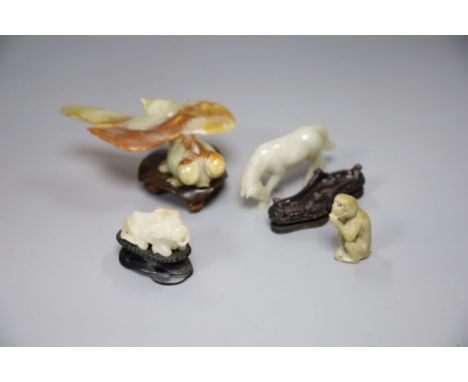 A Chinese jade figure of a buffalo, a hardstone horse and carp and a soapstone monkey