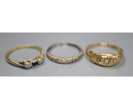 Three assorted 18ct and gem set rings including diamond half eternity, size N, and three stone diamond, size Q, gross 6.1 gra