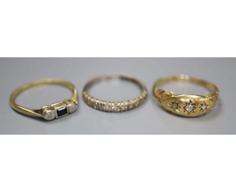 Three assorted 18ct and gem set rings including diamond half eternity, size N, and three stone diamond, size Q, gross 6.1 gra